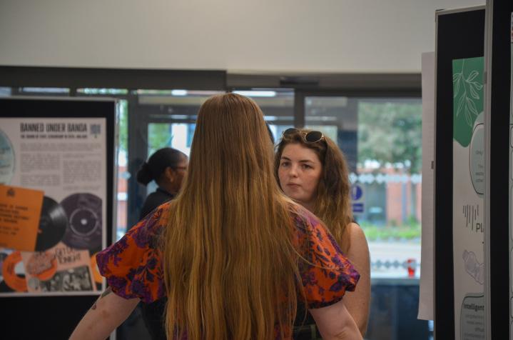Researcher discussing Posters at Showcase Exhibition