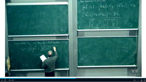 Lecturer writing on chalkboard