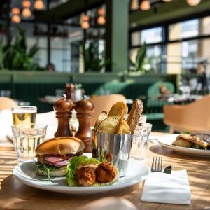 A plate with burger and chips on