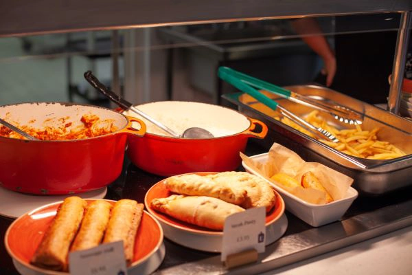 A variety of food staying warm under a heat lamp