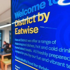 Welcome to District by Eatwise sign