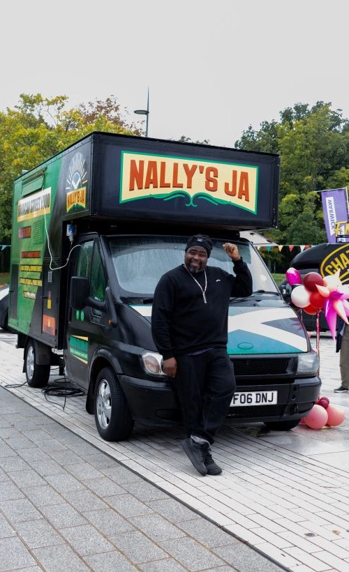 Nelly's Ja Van with a man standing in front