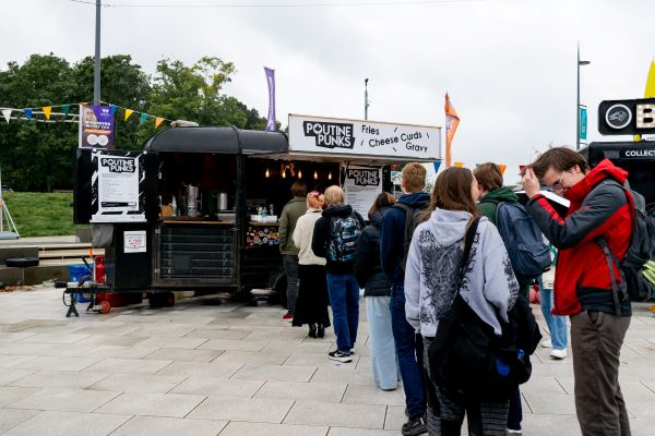 A queue of people for the Poutine Punks Food Truck