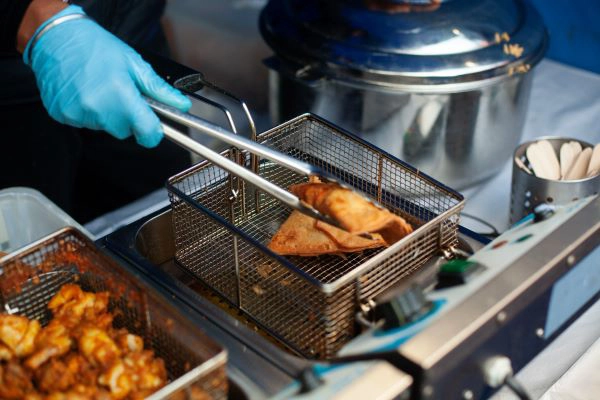 Man frying samosas