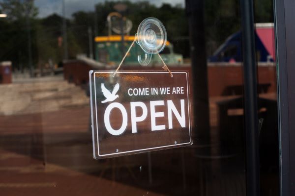 Open sign with a bird on it