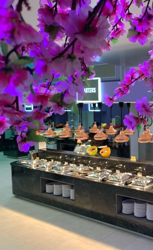 Far shot of lates and cutlery with cheryy blossom leaves in the foreground