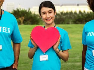 Image of a volunteer holding a heart shape