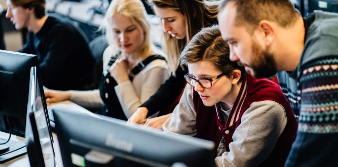 Students looking at computer monitors