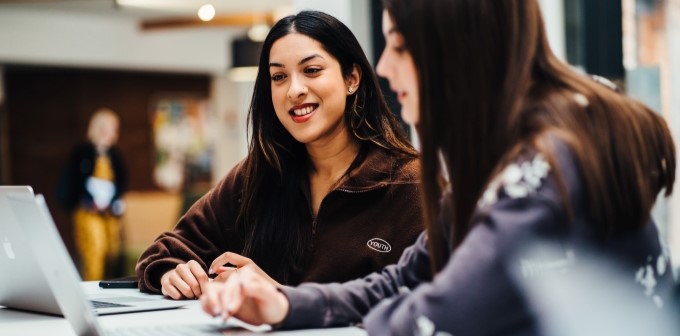 2 students looking at a laptop