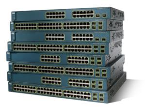 A stack of green rack mounted network switches, some containing 24, others 48 ports. Made by Cisco, similar to those used in our data centre.