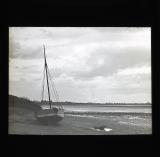 Sailing boat on shore at low tide