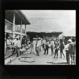 In the U.S. there has been considerable commotion over rubber. Crude rubber gathered by Indians in the forest wilds of Eastern Peru being weighed at a jungle station. America might invest capital for the development of the industry in South America.