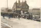 A scene at the Dock Gates: Armoured cars and guards marching in to escort the great food convoy