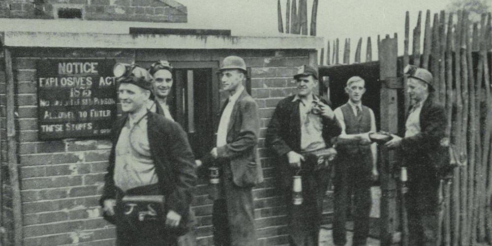 Miners standing outside store for explosives.