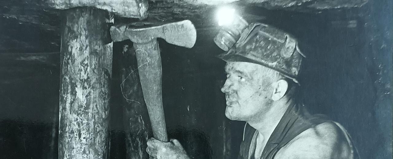 Photograph of a miner underground