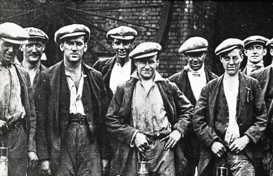 Group of miners looking towards the camera.