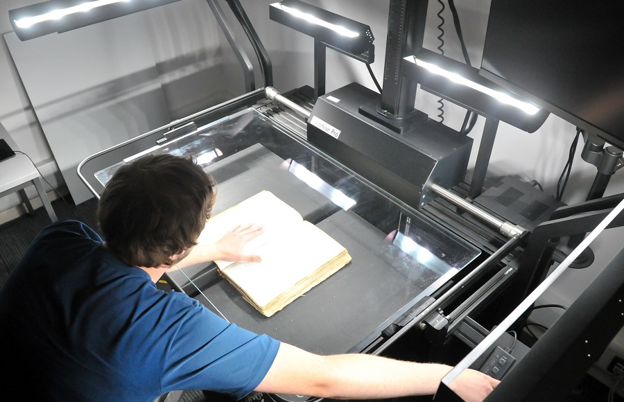 MRC Digitisation Assistant scanning a document.