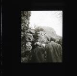 Men watching climbers on cliff