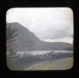 Quellyn [Llyn Cwellyn, Wales?] man with cycles at the lake