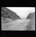 Near Sneem.  W.H. Long. Cyclist map-reading on Irish road