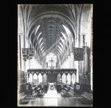 Ornate cathedral interior, flags on display