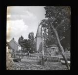 Church tower and other buildings, with boat in the foreground
