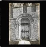 Ornate sculpted door frame around iron braced door