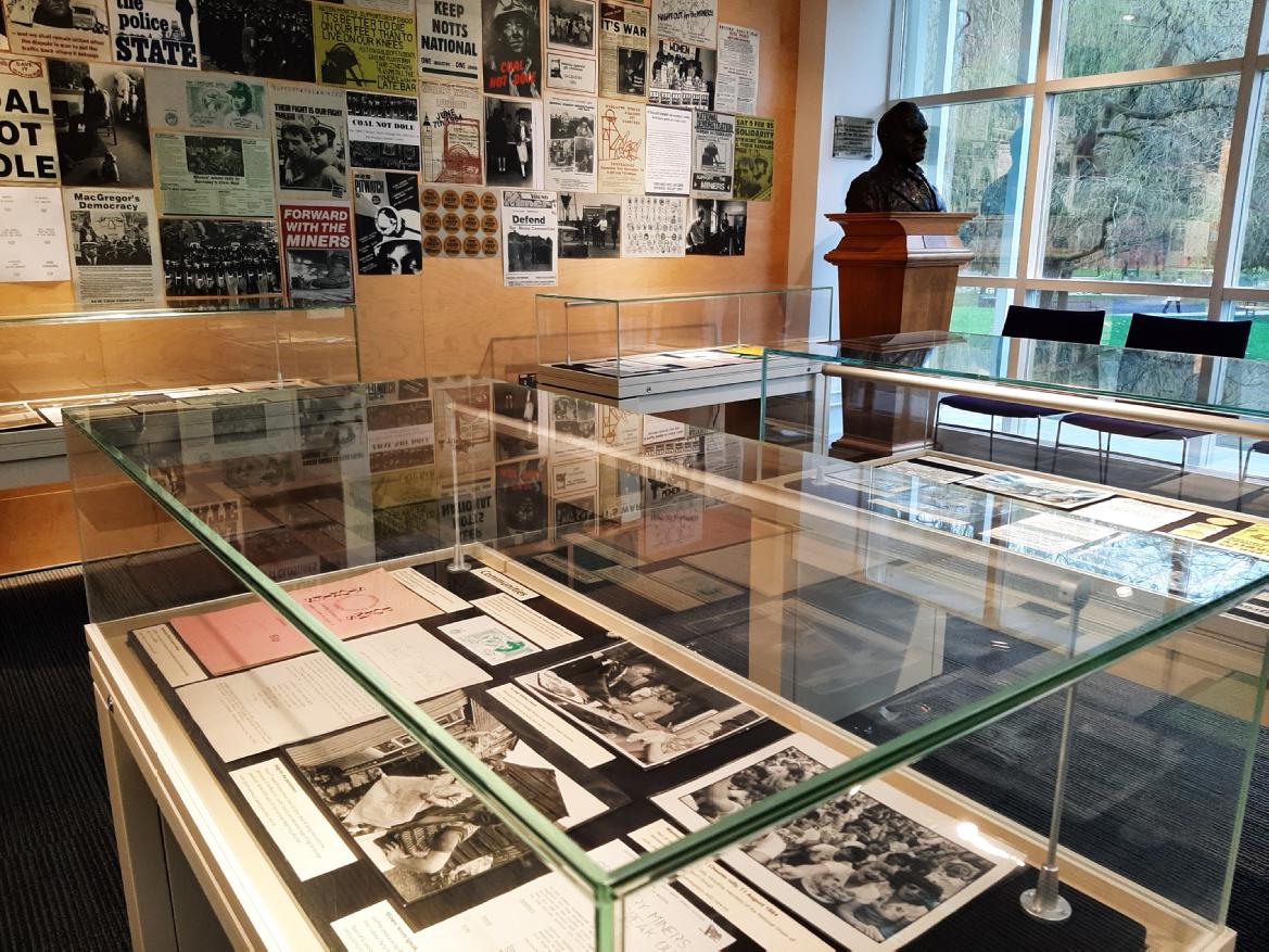 Photograph of the MRC exhibition space, including views of the display cases and posters on the wall