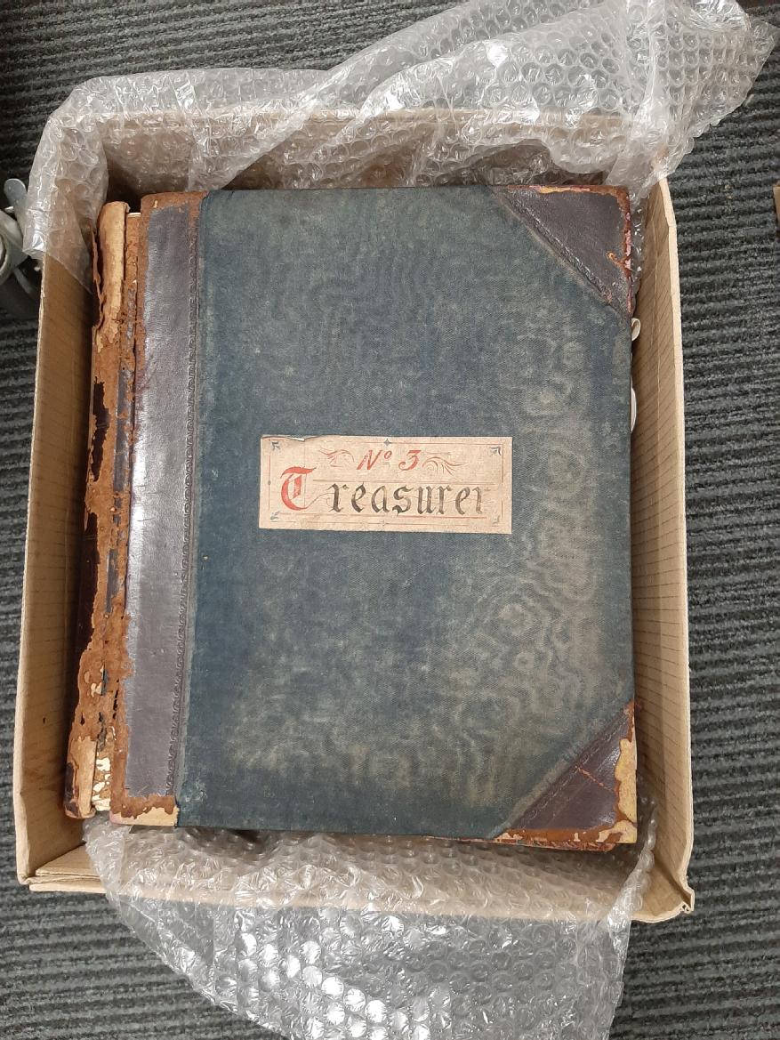 Photograph of an early 20th century Treasurer's ledger in a box