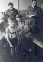 Allied doctors examining a malnourished schoolboy in Hamburg