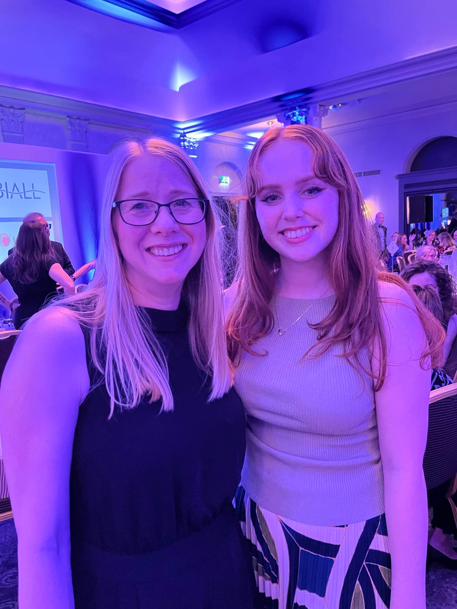 Photo of Jackie Hanes (blond woman) and a previous Library Student Partner (ginger woman) standing together and smiling at the camera.