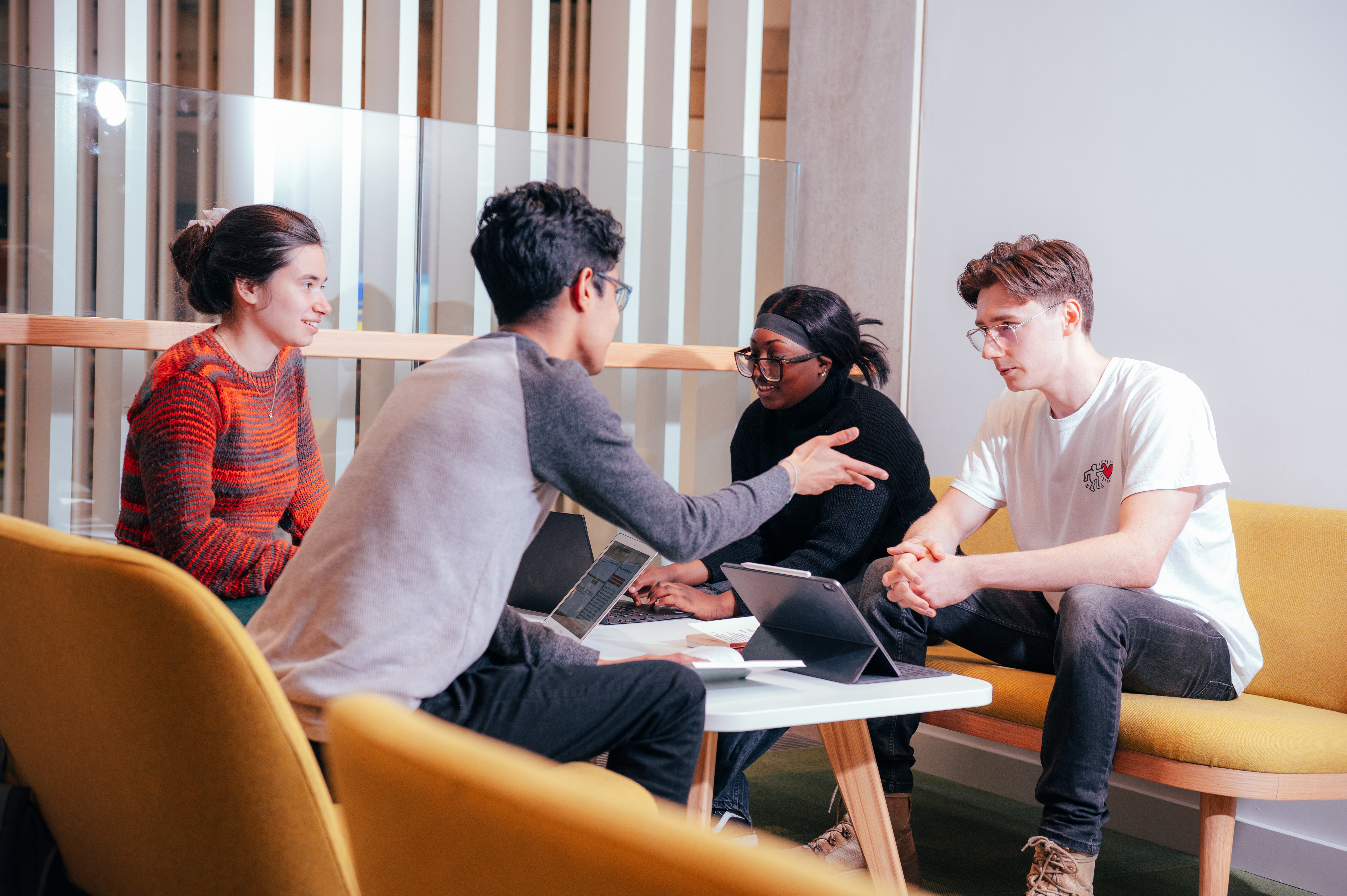 Four students discuss their Philosophy projects in one of the collaboration spaces in the Faculty of Arts Building.