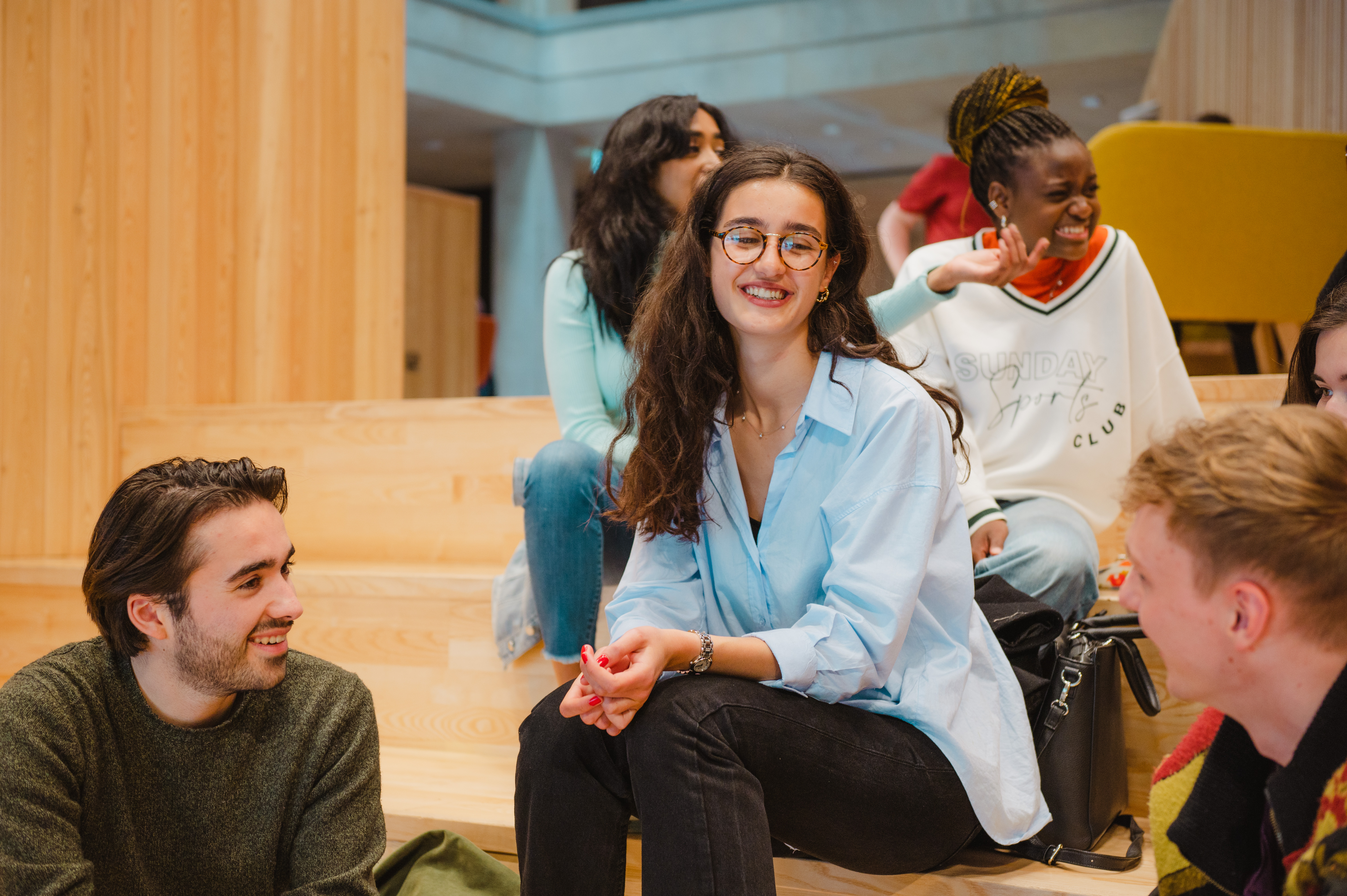 Students discussing their experiences in a communal area at the University of Warwick