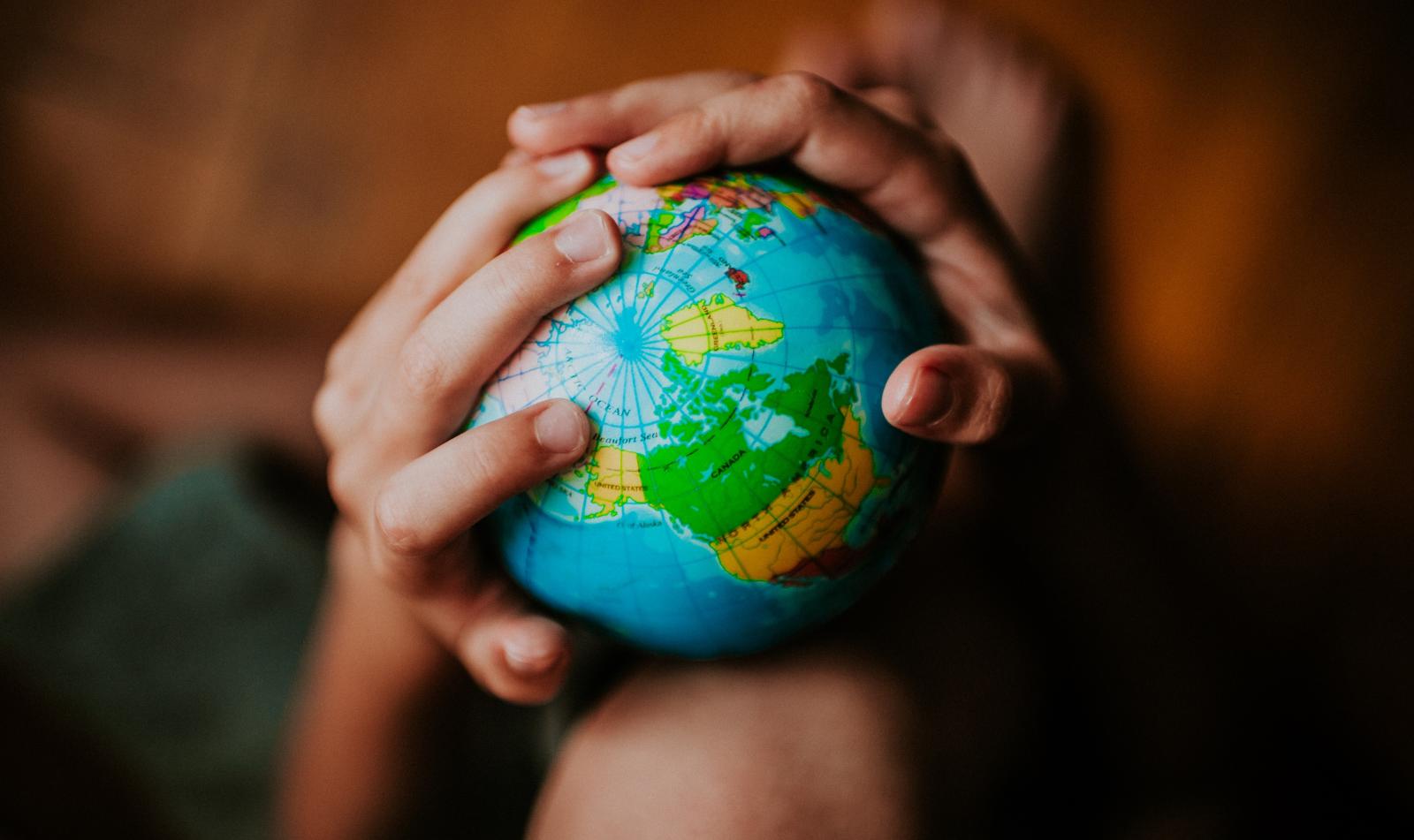 Hands holding a globe of the world