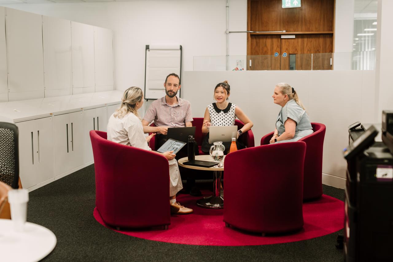 Members of staff in hot desking office
