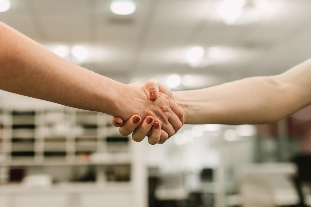 Hand shake with office background