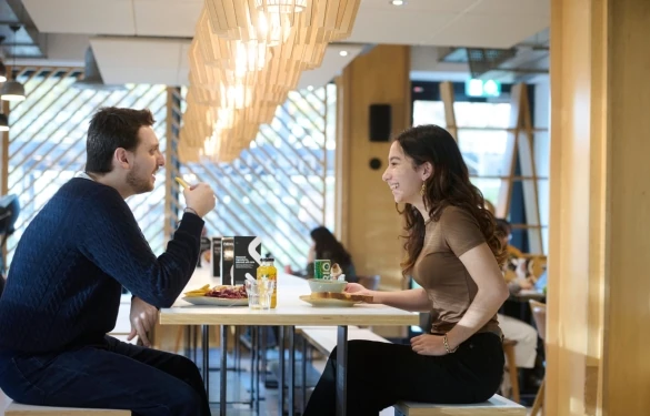 This image of 2 students enjoying dining at Nexus links to our What's On page that shows all offers and events we have on during Welcome Week and beyond