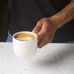 Hand holding a mug of coffee