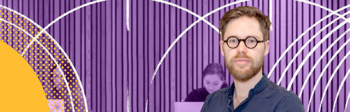 Decorative image - a male white academic in glasses in the foreground looking at the camera, with a group of academics in background working on laptops. Background is a purple overlay, with white arcs and yellow highlights. 