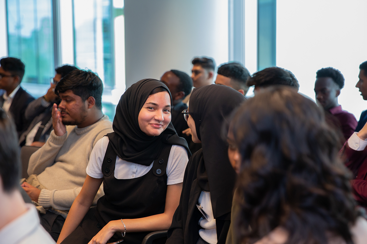 A young muslim woman smiles to the camera at the Smart Futures graduation