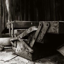 Black and white image of a rusty toolbox