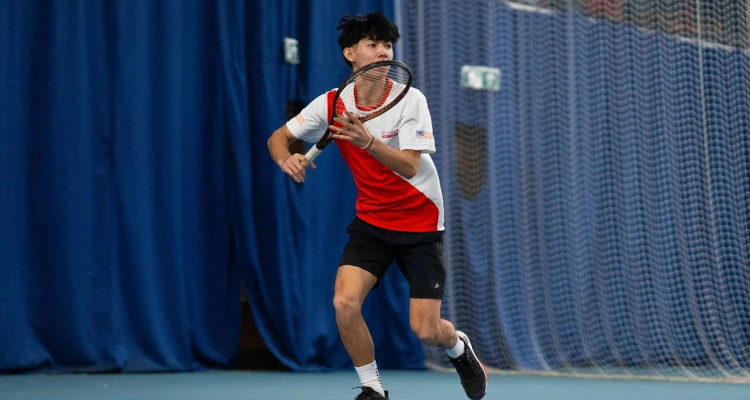 A student playing tennis