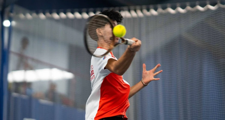 A student playing tennis