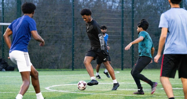 group of people playing 5-a-side football