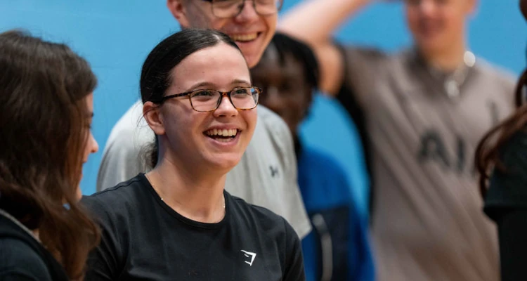 person smiling around a group of people