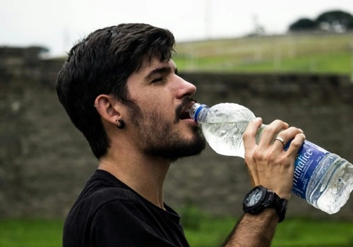 Man drinking from water bottle