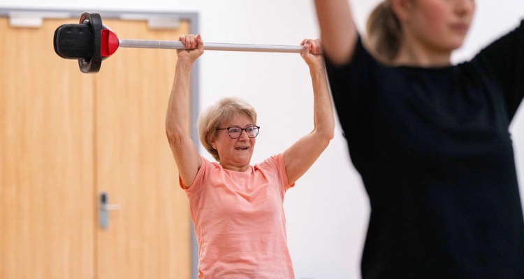 A person raising a barbell above their head