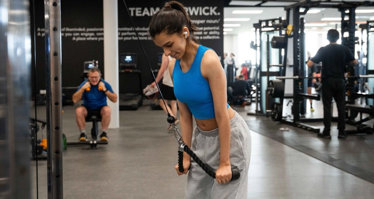 A person using a cable machine at the gym
