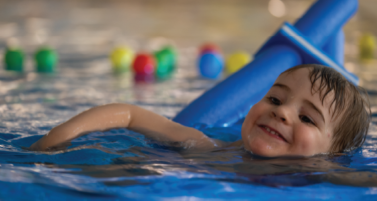 A child learns how to swim.