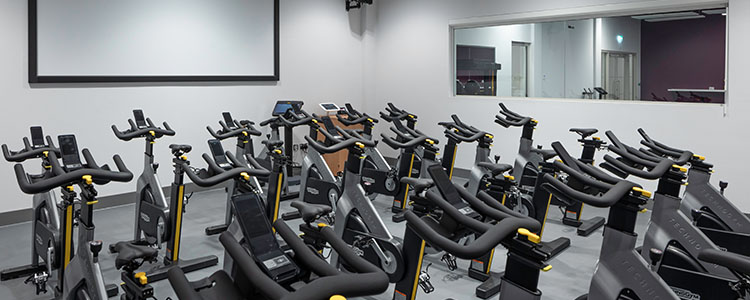 A dedicated cycle studio with plenty of cycling machines for people to workout.